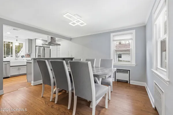 a view of a dining room with furniture and wooden floor
