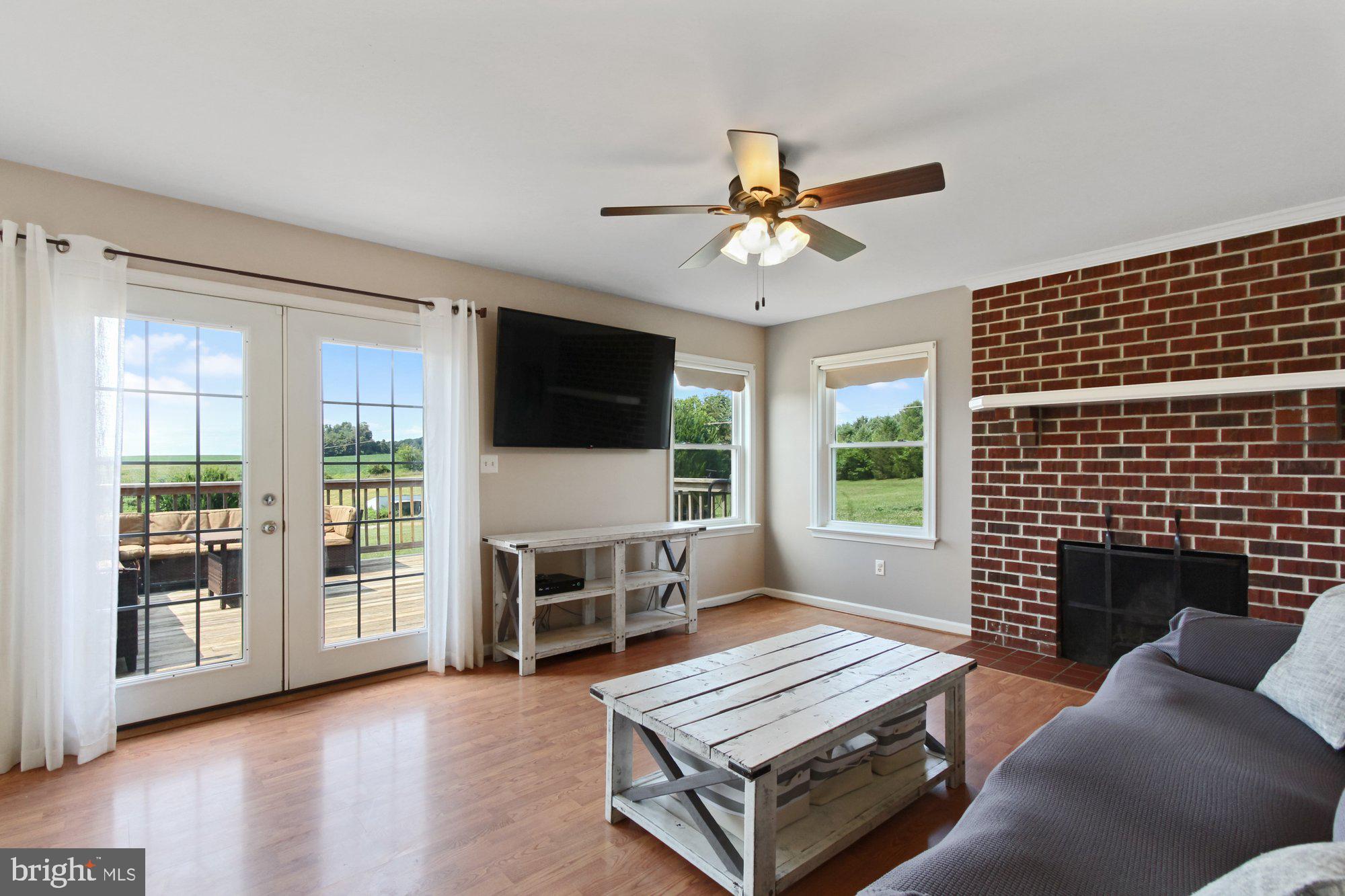 237 Woolen Mill Road New Park, PA 17352 - Photo 11 of 32 Gleaming floors, brick fireplace, walkout to deck
