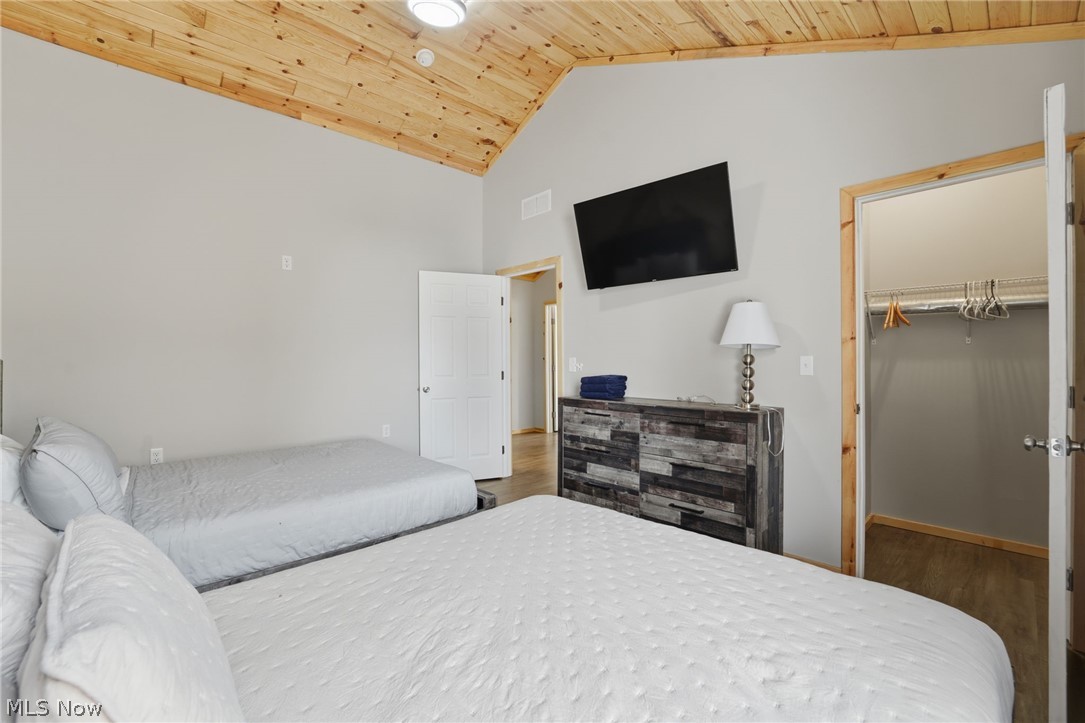 5919 Lake Road West, Unit 33 Ashtabula, OH 44004 - Photo 22 of 22 Bedroom with wood finished floors, a high wood ceiling, and a walk in closet