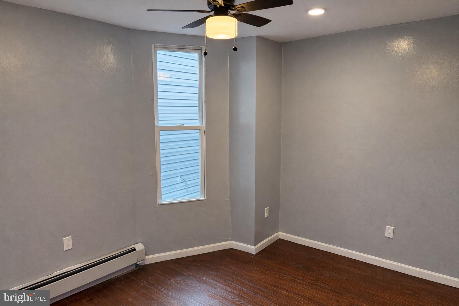 4548 North 17th Street Philadelphia, PA 19140 - Photo 12 of 13 a view of an empty room with window and wooden floor