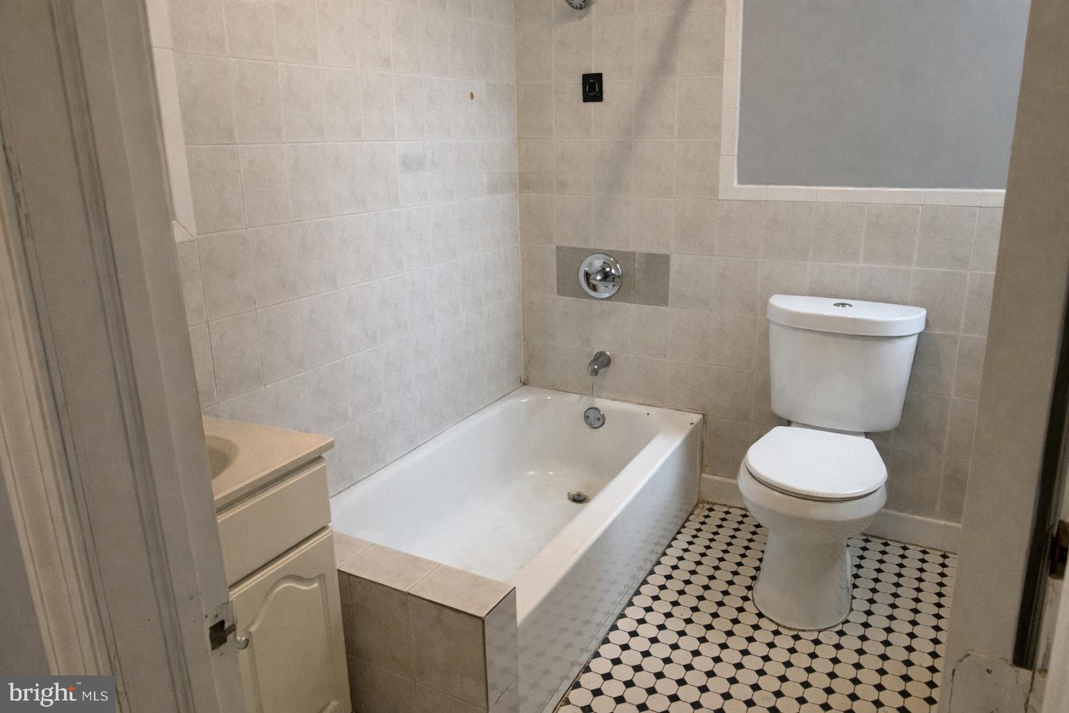 4548 North 17th Street Philadelphia, PA 19140 - Photo 10 of 13 a bathroom with a toilet a sink and a shower