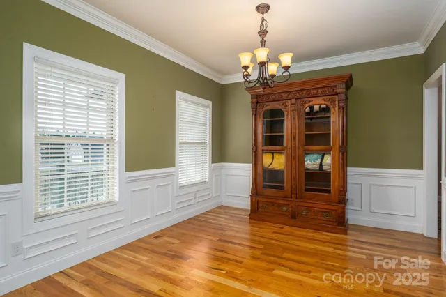 a view of a room with wooden floor and windows