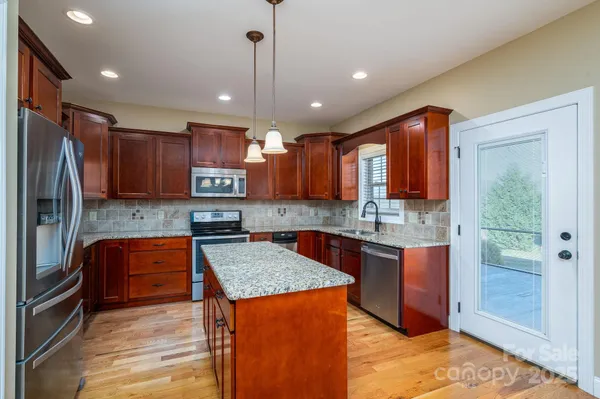 a kitchen with large cabinets appliances and a counter top space
