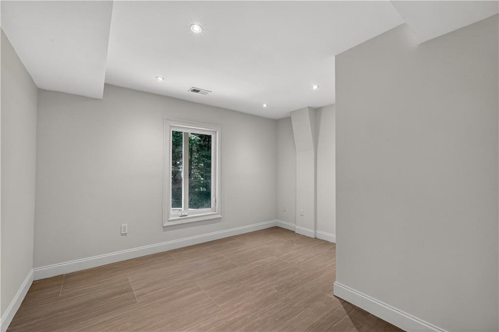 4610 West Morton Road Alpharetta, GA 30022 - Photo 42 of 53 an empty room with wooden floor and windows