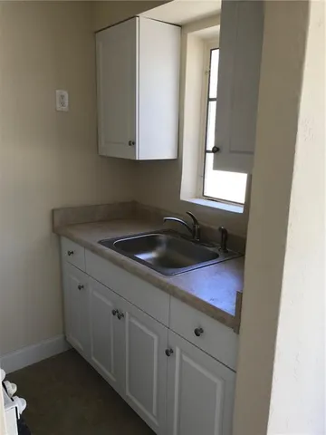 a kitchen with a sink and cabinets