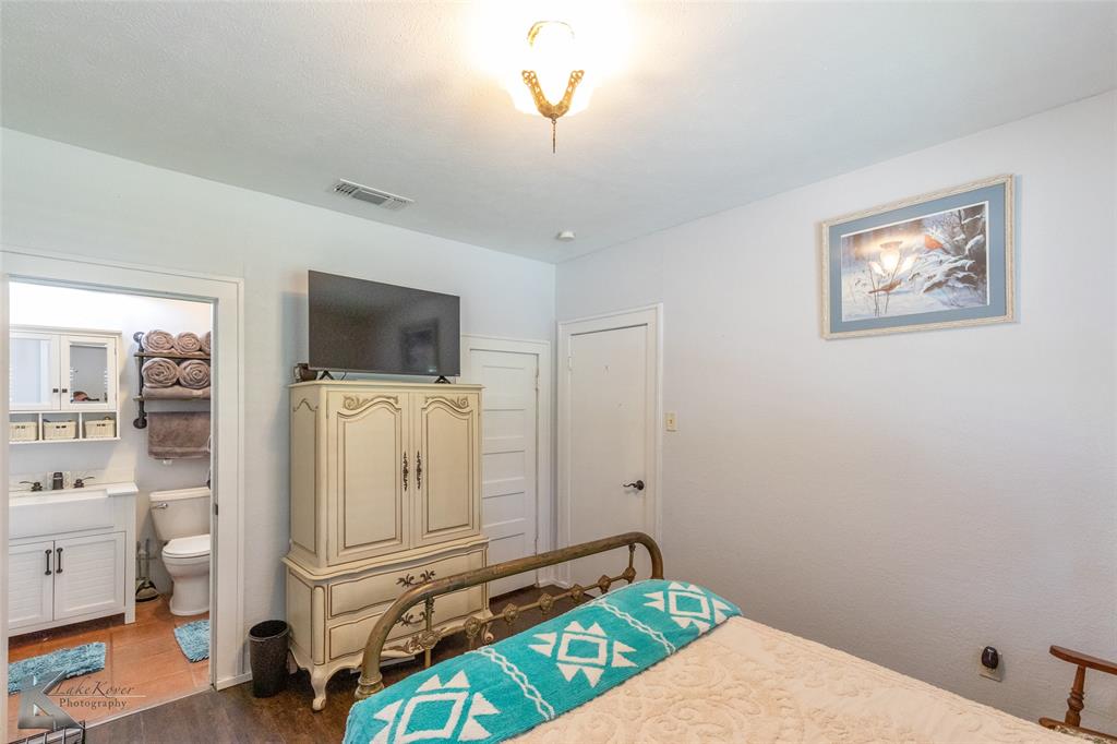 202 East Ross Street Rising Star, TX 76471 - Photo 26 of 40 a living room with furniture and a flat screen tv