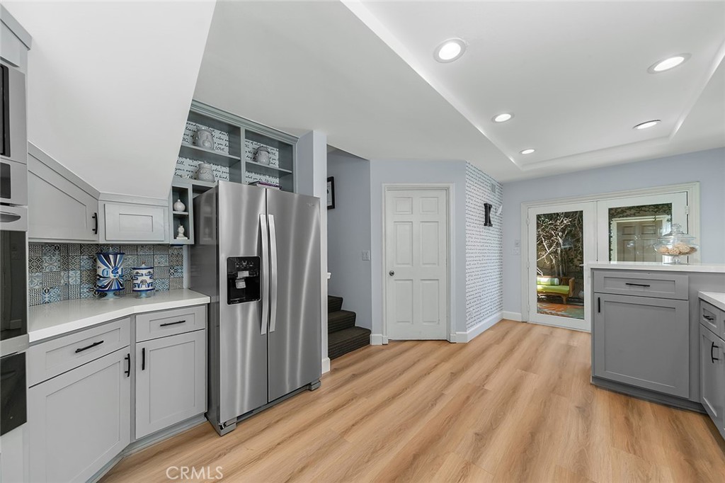 232 7th Street Seal Beach, CA 90740 - Photo 22 of 55 a kitchen with white cabinets and refrigerator