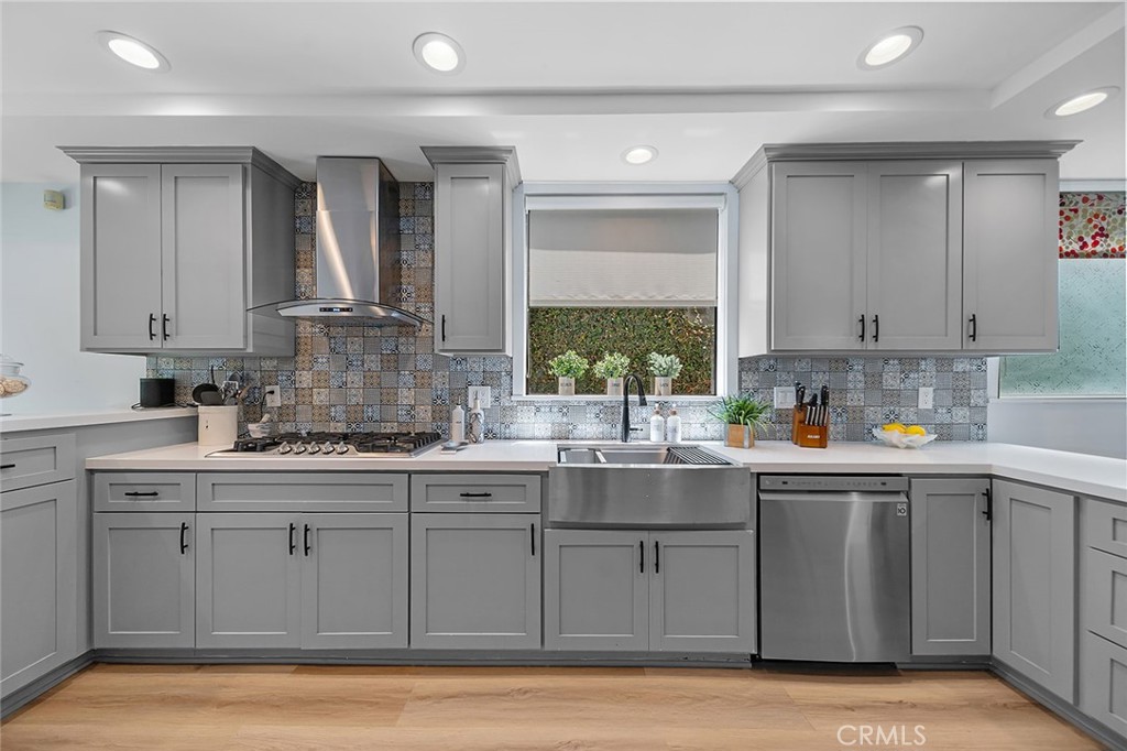 232 7th Street Seal Beach, CA 90740 - Photo 24 of 55 a kitchen with stainless steel appliances granite countertop a sink and cabinets