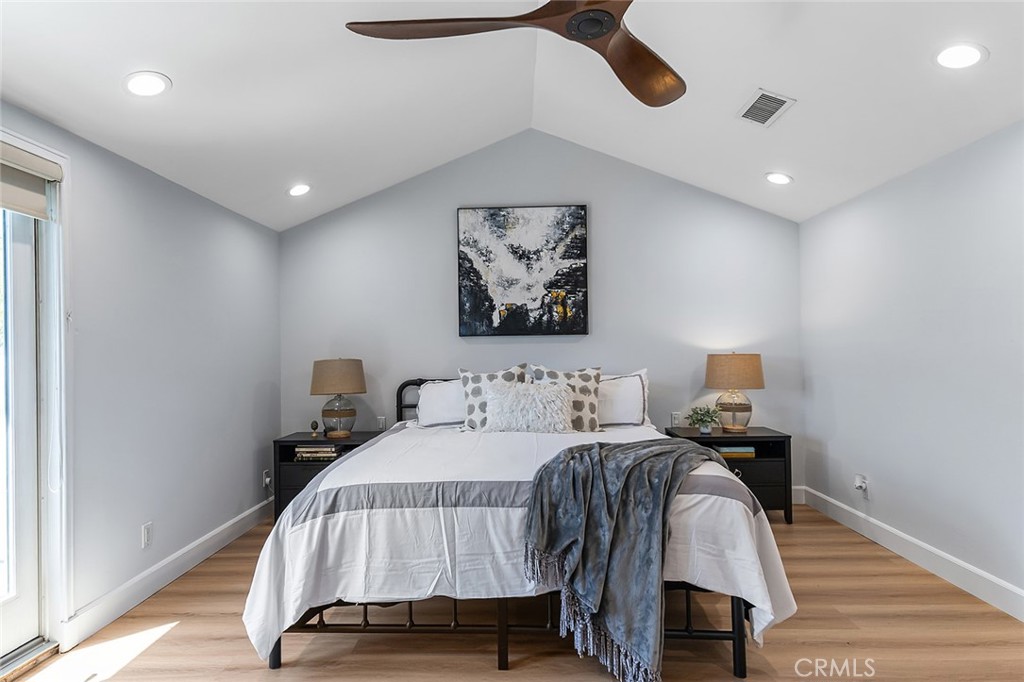 232 7th Street Seal Beach, CA 90740 - Photo 32 of 55 a bedroom with a bed and wooden floor