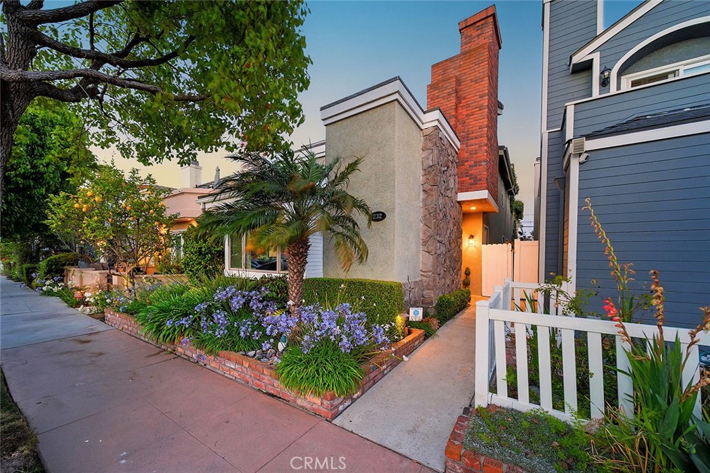 232 7th Street Seal Beach, CA 90740 - Photo 4 of 55 a view of a house with a flower garden
