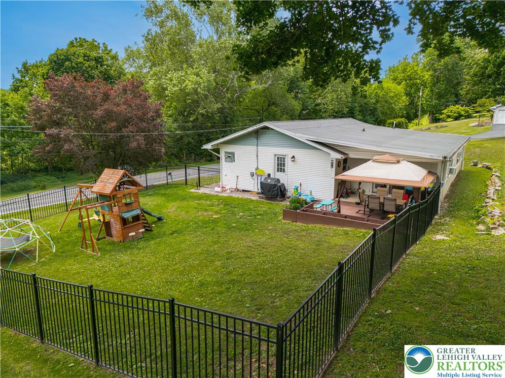 50 Kohls Road Northampton, PA 18067 - Photo 49 of 54 Fenced-in backyard with playful amenities and an inviting outdoor living area.