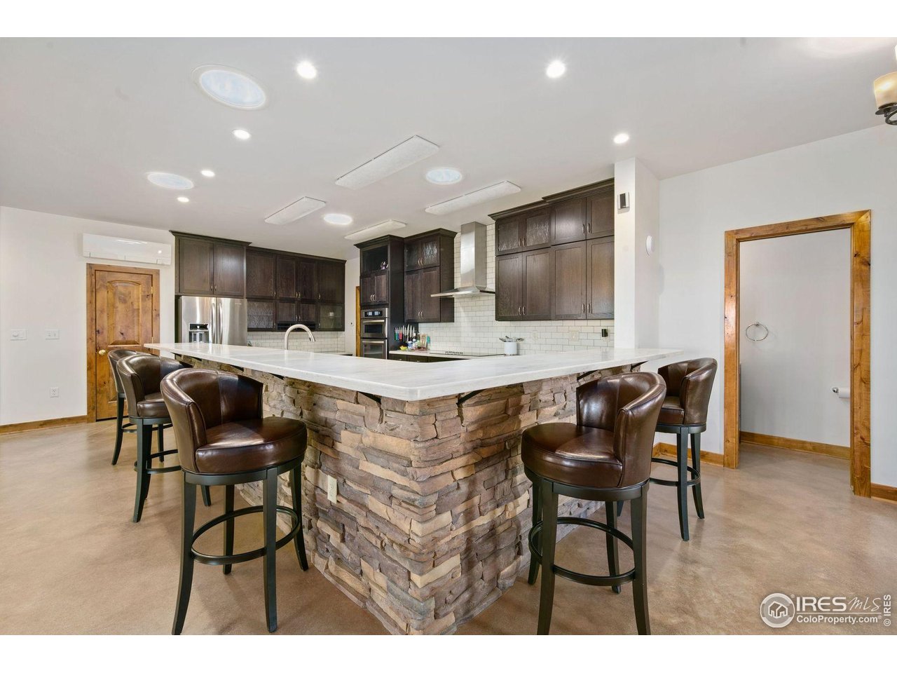 202 Roundtree Road Livermore, CO 80536 - Photo 12 of 50 Large eat at bar surrounding kitchen