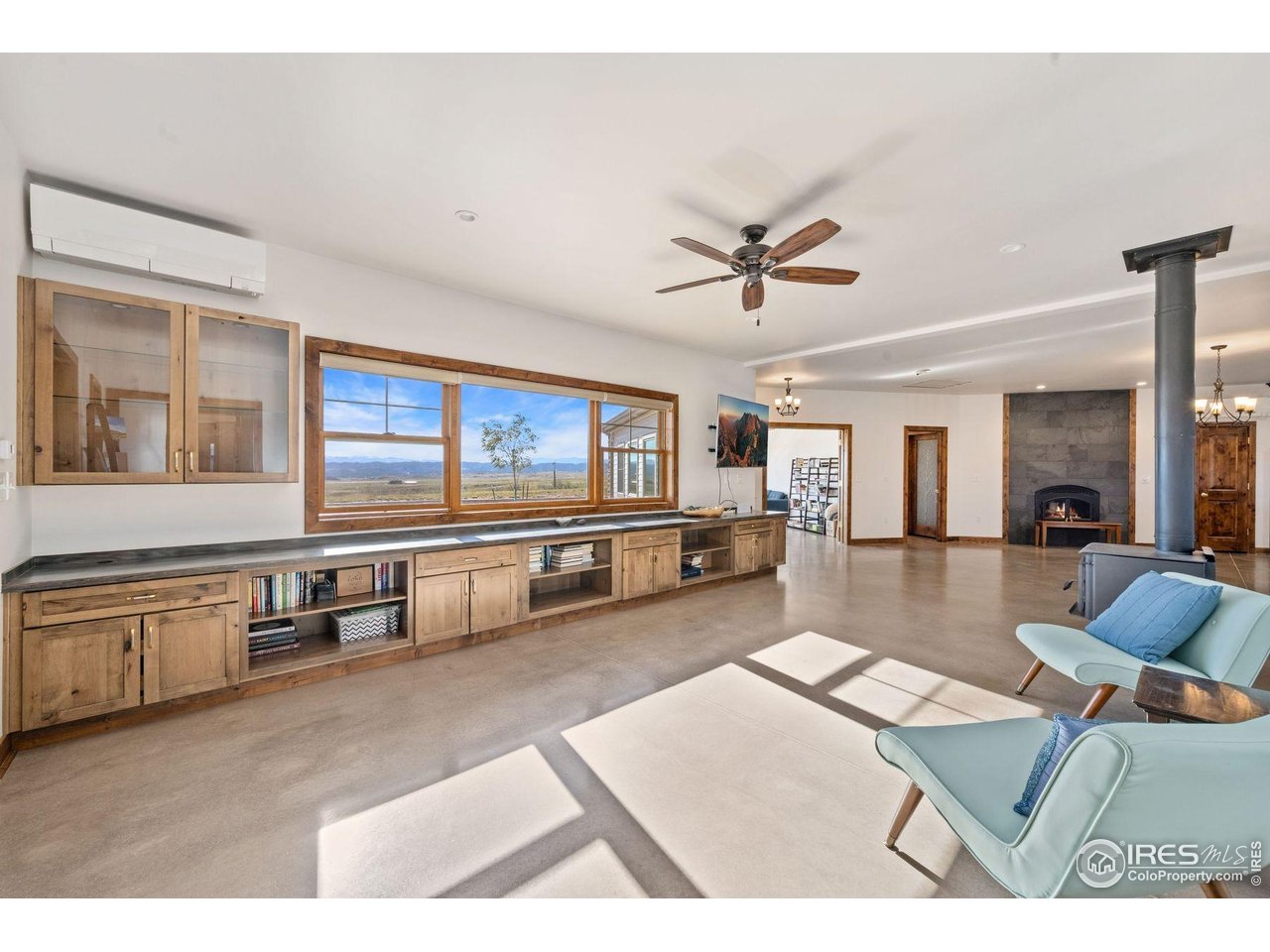 202 Roundtree Road Livermore, CO 80536 - Photo 20 of 50 Living room with fireplace and picture window with jaw dropping mountain views