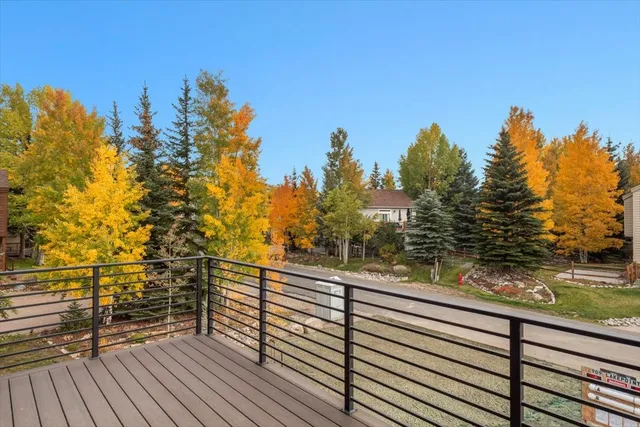 a view of balcony with wooden floor and trees