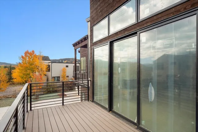 a view of a balcony with wooden floor and iron stairs