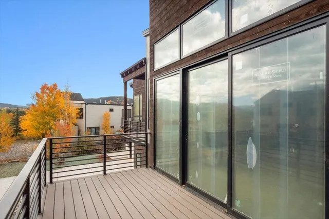 a view of a balcony with wooden floor and iron stairs