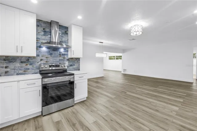 a large kitchen with a lot of counter space and stainless steel appliances