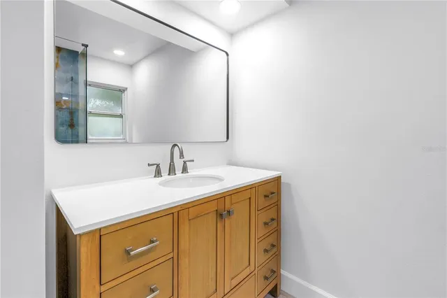 an empty room with wooden floor and ceiling fan