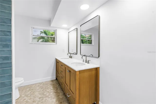 a view of a house with pool plants and large trees