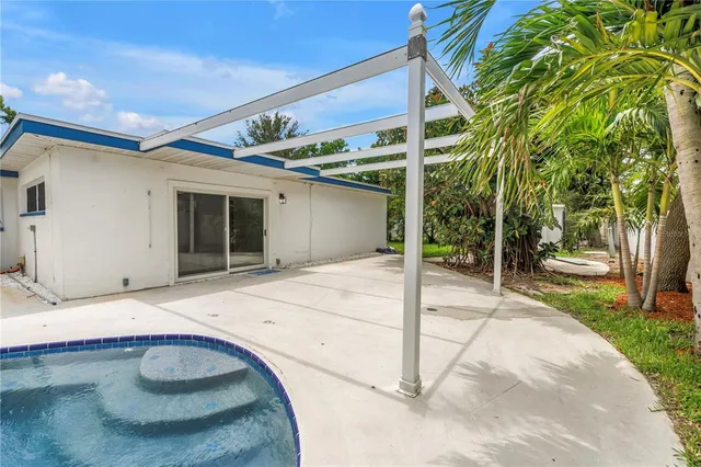 a view of a swimming pool with a yard