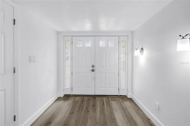 a view of a hallway with wooden floor