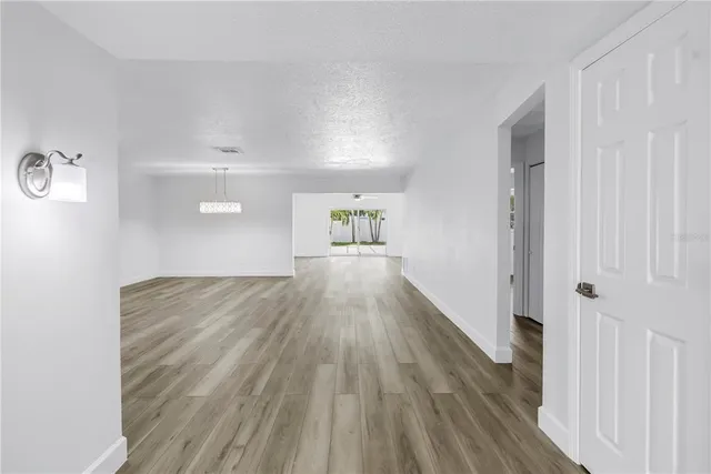a view of a kitchen with a sink and a refrigerator