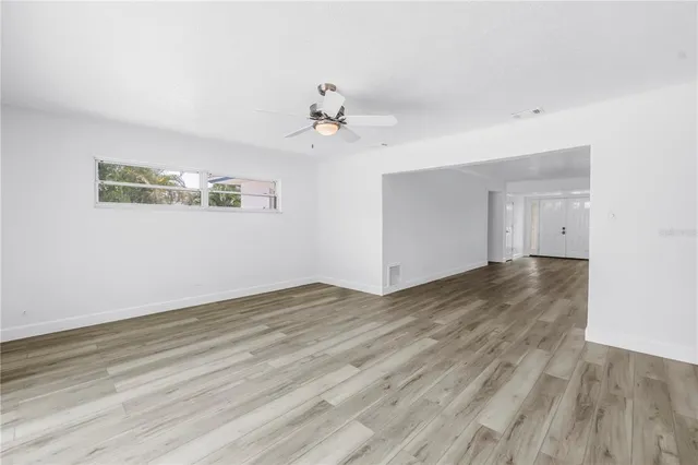 a kitchen with a sink window and cabinets
