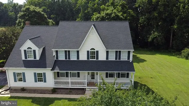 a aerial view of a brick house next to a yard