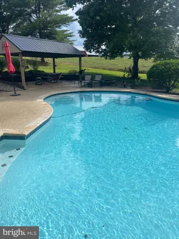 a view of swimming pool with seating space