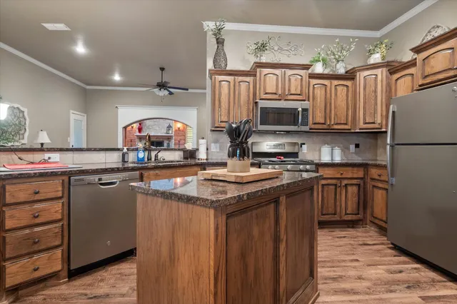 a kitchen with a sink stove and refrigerator