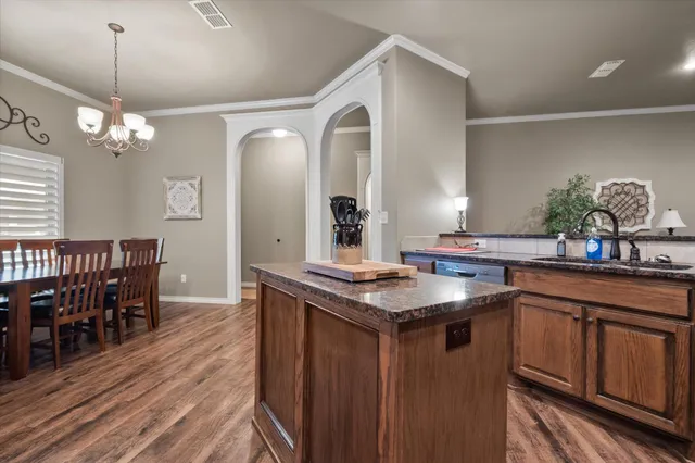 a kitchen with center island table and chairs in it