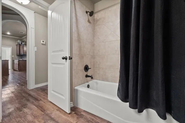 a bathroom with a bathtub and a shower