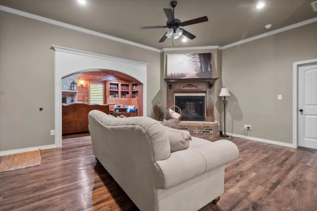 a living room with furniture a fireplace and a chandelier