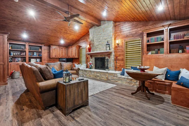 a living room with furniture a fireplace and wooden floor