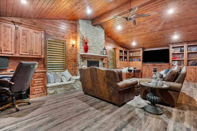 a living room with furniture a flat screen tv and a fireplace