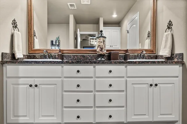 a bathroom with a sink a vanity and a mirror