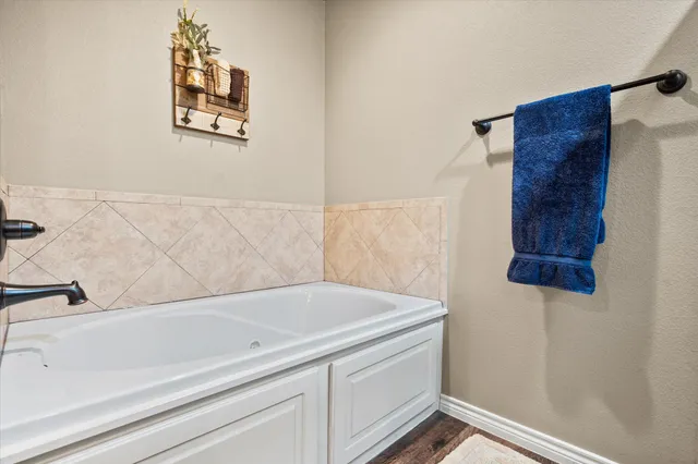 a bathroom with a bathtub and shower