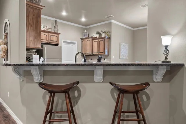 a kitchen with stainless steel appliances a sink and a refrigerator