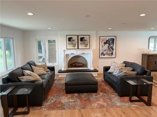 a living room with furniture and a fireplace
