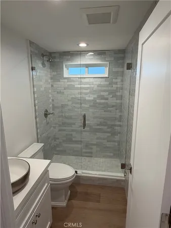 a bathroom with a toilet and a shower