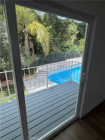 a view of a balcony with wooden floor