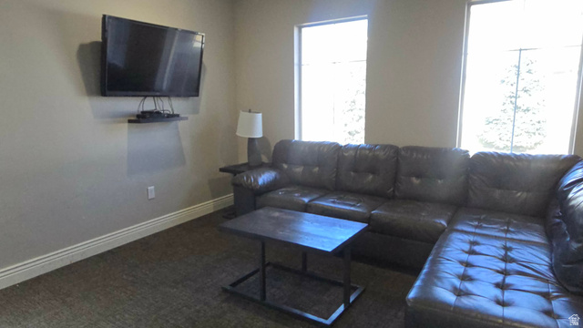 90 East Resaca Drive, Unit C11 Sandy, UT 84070 - Photo 23 of 27 Living room with baseboards and dark colored carpet