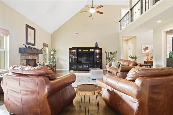 a living room with furniture a fireplace and a chandelier
