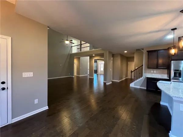 an open space with lots of wooden furniture and a fireplace
