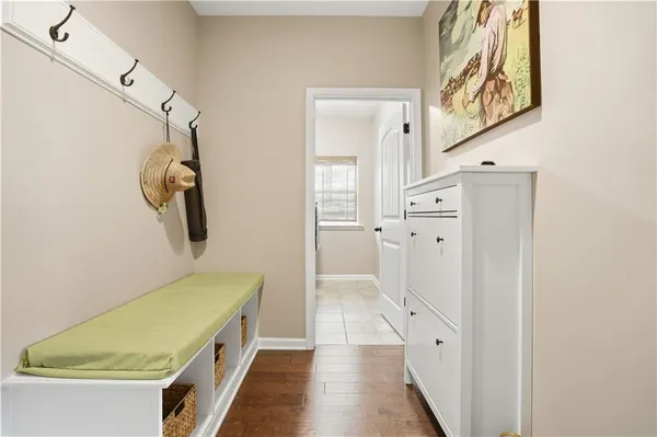 a room with a walk in closet and wooden floor