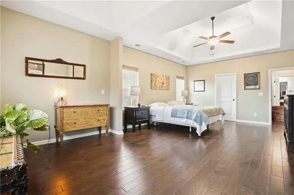 a spacious bedroom with a bed and a chandelier