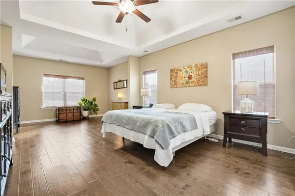 a spacious bedroom with a bed and a chandelier