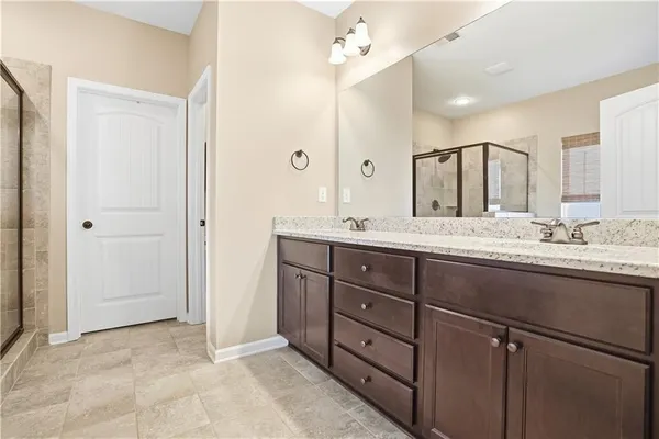 a bathroom with a granite countertop sink mirror and double