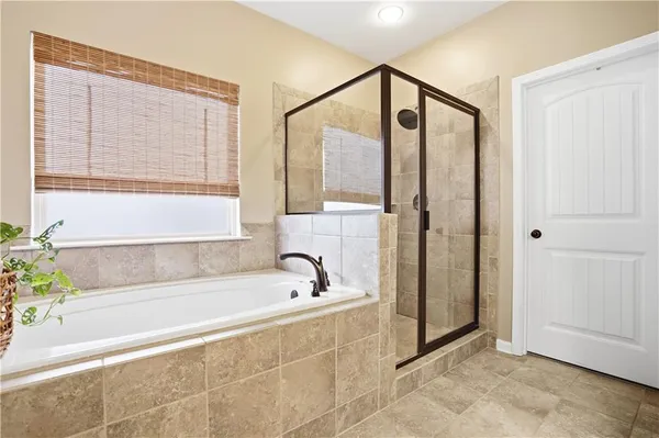 a bathroom with a bathtub and a shower
