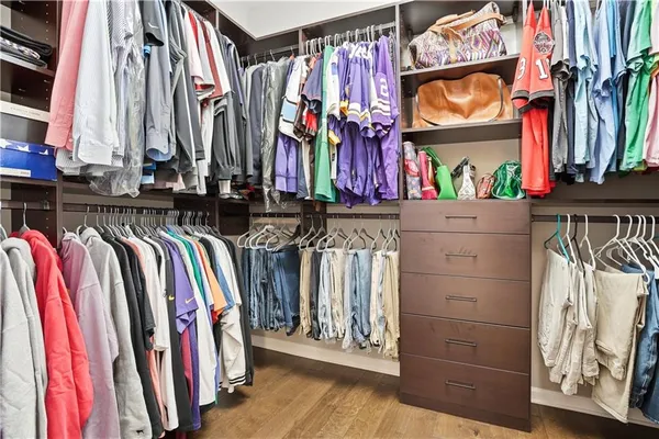 a view of walk in closet with clothes